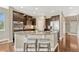 Gourmet kitchen with granite island, breakfast bar, stainless appliances, and sleek dark cabinetry at 19382 Dunraven St, Parker, CO 80134