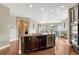 Open kitchen featuring stainless steel dishwasher, granite island, and hardwood floors, with a view to the living space at 19382 Dunraven St, Parker, CO 80134