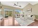 Bright living room features a ceiling fan, large windows and sliding glass doors to a deck, and modern neutral decor at 19382 Dunraven St, Parker, CO 80134