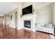 Bright living room features a cozy fireplace and glossy hardwood floors at 19382 Dunraven St, Parker, CO 80134