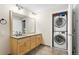 Bathroom features wood vanity, and a stacked washer dryer unit at 1440 Little Raven St # 110, Denver, CO 80202