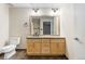 Modern bathroom featuring a wood vanity, tile floors, toilet, and framed mirror at 1440 Little Raven St # 110, Denver, CO 80202