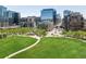 Green city park with modern buildings and a pedestrian bridge at 1440 Little Raven St # 110, Denver, CO 80202