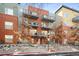 Brick condo building with balconies, visible signage and winter foliage at 1440 Little Raven St # 110, Denver, CO 80202