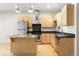 Well-equipped kitchen with stainless steel appliances, light wood cabinetry, and a functional center island for meal preparation at 1440 Little Raven St # 110, Denver, CO 80202