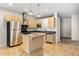 Spacious kitchen featuring stainless steel appliances, light wood cabinets, and a center island for food preparation and storage at 1440 Little Raven St # 110, Denver, CO 80202