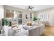 Inviting living room featuring a plush sofa, a modern ceiling fan, and access to a private outdoor balcony at 1440 Little Raven St # 110, Denver, CO 80202