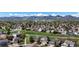 Expansive aerial view showcases a neighborhood surrounded by lush greenery and mountains in the background at 11191 W Crestline Dr, Littleton, CO 80127