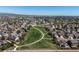 Aerial view showcasing a neighborhood with green spaces, walking paths and neatly arranged homes at 11191 W Crestline Dr, Littleton, CO 80127