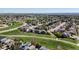 This aerial view shows a neighborhood full of houses and green landscape under a clear blue sky at 11191 W Crestline Dr, Littleton, CO 80127