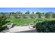 A lush backyard with green grass, bushes, a wooden fence, and a view of the neighborhood at 11191 W Crestline Dr, Littleton, CO 80127