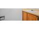 Close up of a wooden bathroom vanity, toilet paper holder and beige countertop at 11191 W Crestline Dr, Littleton, CO 80127