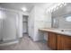 Bright bathroom featuring tile flooring, walk-in shower, and vanity with great lighting at 11191 W Crestline Dr, Littleton, CO 80127