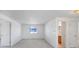 This bedroom features neutral carpet, a large window for natural light, and fresh, white walls at 11191 W Crestline Dr, Littleton, CO 80127