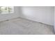 Neutral bedroom featuring clean carpet, large windows bringing in natural light, and closet at 11191 W Crestline Dr, Littleton, CO 80127