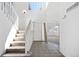 Foyer with staircase, tile flooring, and natural light, leading to the home's interior at 11191 W Crestline Dr, Littleton, CO 80127