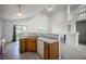 Kitchen area, with view of backyard, opens to living room with fireplace and staircase at 11191 W Crestline Dr, Littleton, CO 80127