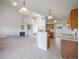 Open-concept living room and kitchen with lots of natural light and an inviting fireplace at 11191 W Crestline Dr, Littleton, CO 80127
