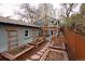 Charming backyard with raised garden beds, stone pathway, and a detached garage at 569 S Race St, Denver, CO 80209