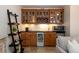 Home bar area featuring custom cabinetry, a wine fridge, and a countertop with sink at 569 S Race St, Denver, CO 80209