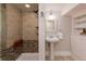 Updated bathroom features a walk-in shower with a built-in seat and pedestal sink at 569 S Race St, Denver, CO 80209