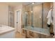 Modern bathroom with tiled shower, separate soaking tub, and vanity with sink at 569 S Race St, Denver, CO 80209