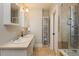 Tiled bathroom featuring double sinks, a shower over tub and neutral wall colors at 569 S Race St, Denver, CO 80209