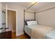 Bedroom features hardwood floors, light neutral paint, canopy bed and direct access to adjacent room at 569 S Race St, Denver, CO 80209