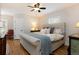 Comfortable bedroom features a queen-sized upholstered bed, hardwood floors and shuttered windows at 569 S Race St, Denver, CO 80209