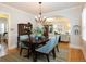 Open dining room featuring hardwood floors, archway view of the living room, and stylish furniture at 569 S Race St, Denver, CO 80209