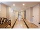 Bright finished basement hallway with tile flooring, neutral colors, and access to multiple rooms at 569 S Race St, Denver, CO 80209