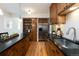 Modern kitchen with stainless steel appliances, wooden cabinets, and dark countertops at 569 S Race St, Denver, CO 80209