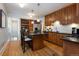 Spacious kitchen with stainless steel appliances, wooden cabinetry, island, and hardwood floors at 569 S Race St, Denver, CO 80209