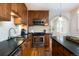 Updated kitchen with stainless steel appliances, granite countertops, and wooden cabinetry at 569 S Race St, Denver, CO 80209
