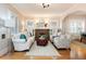 Bright living room featuring a decorative fireplace, hardwood floors, and an archway to other rooms at 569 S Race St, Denver, CO 80209