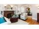 Open living room with fireplace, hardwood floors, and an archway leading to the dining room at 569 S Race St, Denver, CO 80209