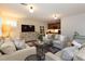 Spacious living room with stylish decor, a large TV, and a view into the adjoining bar area at 569 S Race St, Denver, CO 80209