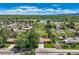 Elevated view of the house, showcasing the landscaping, proximity to nearby open land, and quiet neighborhood at 11310 W 46Th Ave, Wheat Ridge, CO 80033