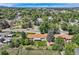 Aerial view showcasing the property, mature trees, a fenced backyard, and surrounding neighborhood at 11310 W 46Th Ave, Wheat Ridge, CO 80033