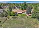 Aerial shot of the property, displaying the fenced backyard, shed, patio, and mature trees at 11310 W 46Th Ave, Wheat Ridge, CO 80033