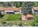 Aerial perspective of fenced backyard featuring a patio, shed, and mature trees at 11310 W 46Th Ave, Wheat Ridge, CO 80033