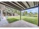Backyard with covered patio, green lawn, mature trees, and a storage shed at 11310 W 46Th Ave, Wheat Ridge, CO 80033