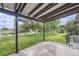 Covered patio area with a spacious backyard featuring green grass and mature trees at 11310 W 46Th Ave, Wheat Ridge, CO 80033