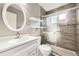Updated bathroom featuring a vanity, shower with glass doors, and stylish tile at 11310 W 46Th Ave, Wheat Ridge, CO 80033