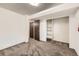 This bedroom features neutral walls, carpet, and a built-in closet with shelving for ample storage at 11310 W 46Th Ave, Wheat Ridge, CO 80033
