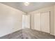 Bedroom with neutral walls, soft grey carpet, and a closet with sliding doors at 11310 W 46Th Ave, Wheat Ridge, CO 80033