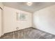 Bright bedroom featuring neutral walls, grey carpet, and a window with natural light at 11310 W 46Th Ave, Wheat Ridge, CO 80033