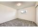 Well-lit bedroom features neutral walls, plush carpet, and a window with outside views at 11310 W 46Th Ave, Wheat Ridge, CO 80033