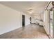 Bright kitchen featuring white appliances, countertops and cabinets, with an adjacent living area at 11310 W 46Th Ave, Wheat Ridge, CO 80033