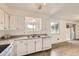 Clean, white kitchen featuring granite countertops and access to the dining area, creating a functional space at 11310 W 46Th Ave, Wheat Ridge, CO 80033